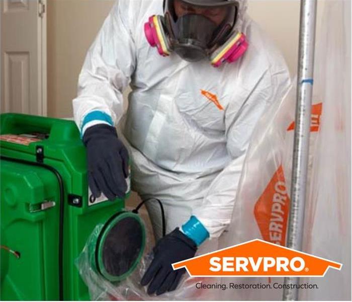 SERVPRO employee in PPE with logo in bottom right corner
